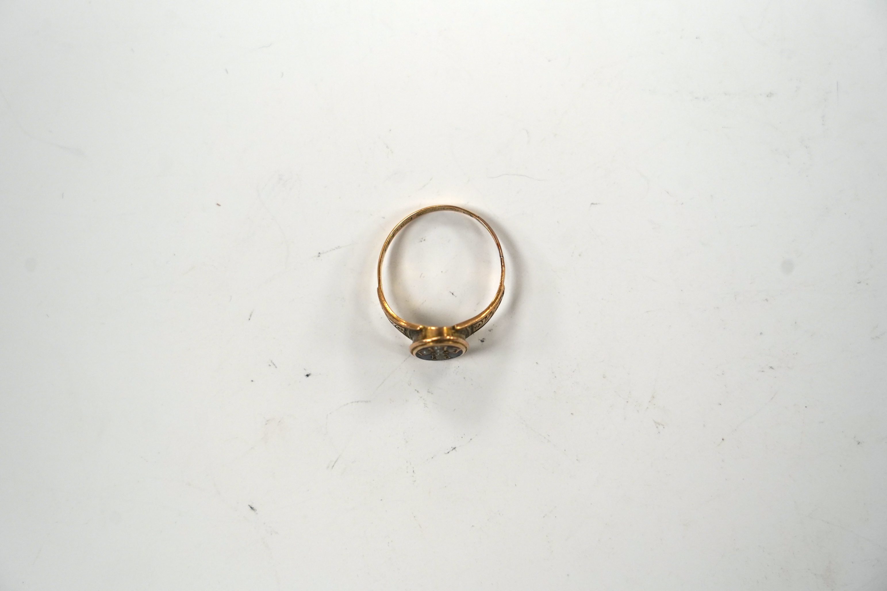 A Victorian 15ct gold black enamel and seed pearl set mourning ring, size Q, gross weight 2.3 grams.